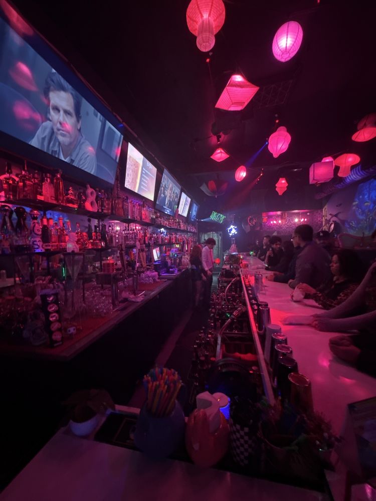 Inside The Rabbit Hole, with pink hanging lanterns and the illuminated bar