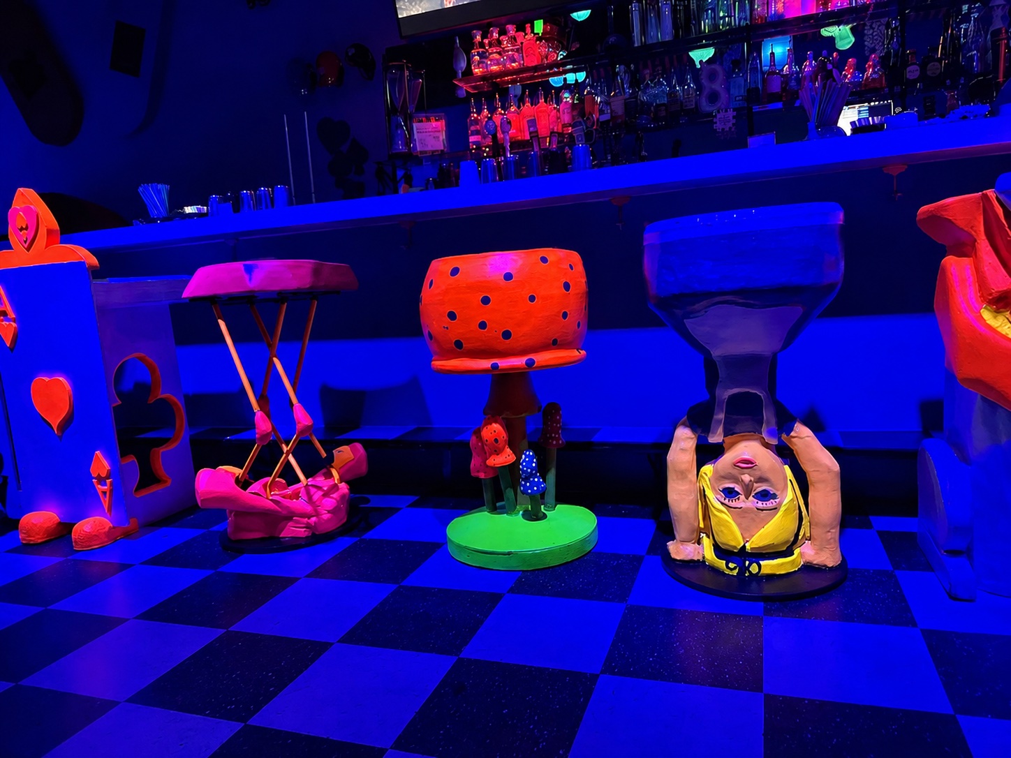 Handcrafted mushroom, hourglass and Alice stools inside The Rabbit Hole